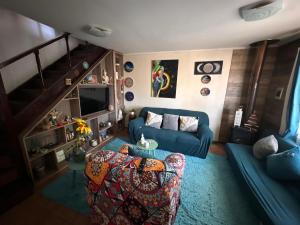 an aerial view of a living room with a blue couch at Casa Isis in Constitución