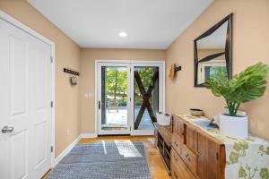 a bathroom with a wooden dresser and a mirror at Blue Beech Cottage in Union Pier +30 photos