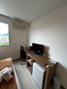 a room with a desk with a computer on it at Apartamentos no Verano Stay in Rio de Janeiro +53 photos