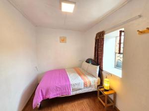 Postel nebo postele na pokoji v ubytování Barrio Inka B&B