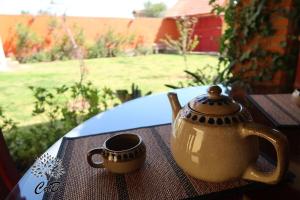 a tea pot and a cup sitting on a table at Cabaña Corazón del Bosque in Huasca de Ocampo