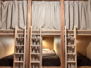a couple of bunk beds in a room at Guest House & Cafe Yamaboushi in Tsushima