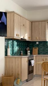 a kitchen with wooden cabinets and a stove at Dry martini in Mirina