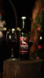 a bottle of wine and a glass on a table at Rancho Porvenir in Mocoa