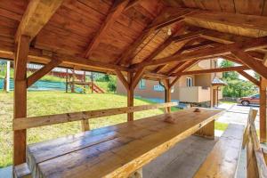 a wooden bench sitting inside of a pavilion at Apartments for families with children Jasenak, Karlovac - 23804 in Jasenak +5 photos