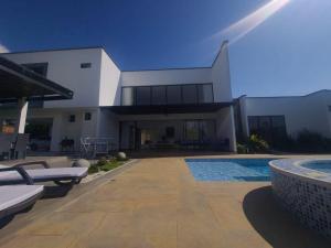a large house with a swimming pool in front of it at Hermosa Casa de Lujo en LAGO CALIMA in Darién
