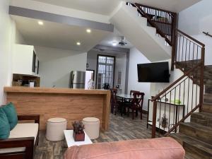 a living room with a staircase and a couch at Casa G&V X9 personas in Santa Elena