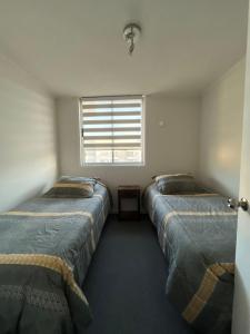 Ένα ή περισσότερα κρεβάτια σε δωμάτιο στο Departamento equipado 302 Ovalle