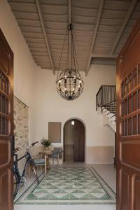 a hallway with a chandelier in a building at Casa Meraki Mérida - Paseo de Montejo in Mérida