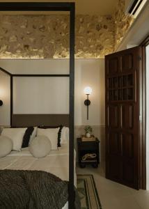 a bedroom with a canopy bed and a door at Casa Meraki Mérida - Paseo de Montejo in Mérida +28 photos