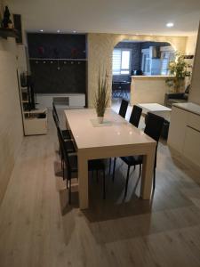 a kitchen and dining room with a table and chairs at Bienvenue in Noyers-sur-Cher +13 photos