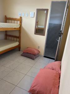 a room with two bunk beds and a mirror at RoseMarAzul Temporadas in Cabo Frio +5 photos