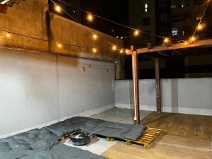 a bed on the floor of a building with lights at Terraza hostel in Itajaí