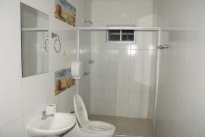 a bathroom with a toilet and a sink and a shower at Hotel Barcelona in Montería +21 photos