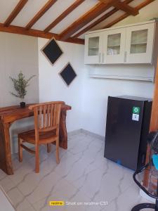 a kitchen with a table and a chair and a refrigerator at Wiwik sweet villa in Amed +27 photos