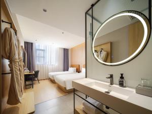 Ein Bett oder Betten in einem Zimmer der Unterkunft 桔作酒店（郑州经开中原福塔东地铁站店）