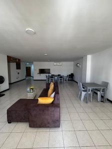 a living room with a couch and a table at Hostal Tayrona in Santa Marta