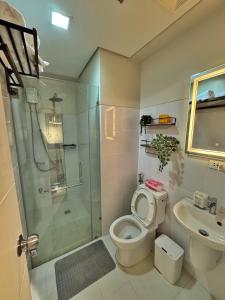 a bathroom with a shower and a toilet and a sink at Casa de gloria in Davao City