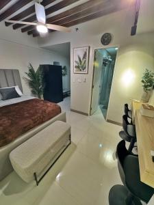 a bedroom with a bed and a ceiling fan at Casa de gloria in Davao City