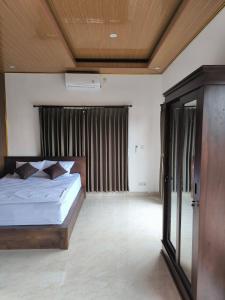 Postel nebo postele na pokoji v ubytování Apollo Homestay