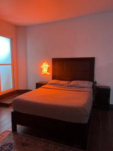a bedroom with a bed and a light on the wall at Departamento Zona Hospital in Zamora de Hidalgo +14 photos