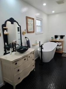 a bathroom with a tub and a sink and a mirror at Gatliff Getaway in Warsaw +18 photos
