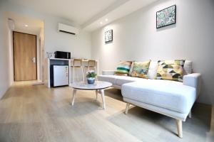 a living room with a couch and a table at jasminespace in Khlong San