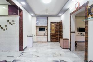 an empty room with a door and a tile floor at ZenStays - Premium Service Apartment in Mulund West in Mumbai