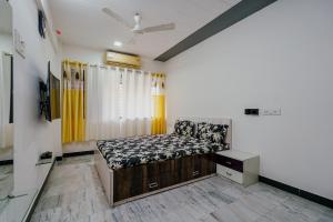 a bedroom with a bed and a tv in it at ZenStays - Premium Service Apartment in Mulund West in Mumbai