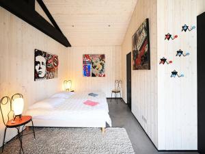 a bedroom with a bed and posters on the wall at Maison spacieuse avec parking proche de la mer - FR-1-434-117 in Ars-en-Ré +19 photos