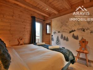 a bedroom with a bed in a log cabin at Chalet au Grand Bornand – 6 Chambres Spacieuses & Ambiance Chaleureuse - FR-1-391-194 in Le Grand-Bornand