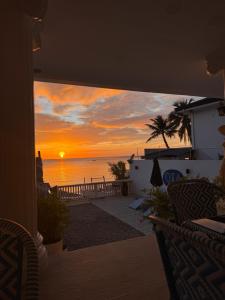 a view of a sunset from the balcony of a house at OIA by Seascape in Bauan