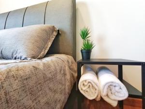 a bed with towels on it next to a table at Luxury Sky Pool 8-Pax City Centre Beacon in George Town +43 photos