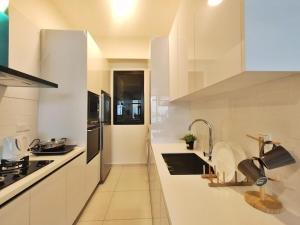 a white kitchen with a sink and a stove at Luxury Sky Pool 8-Pax City Centre Beacon in George Town