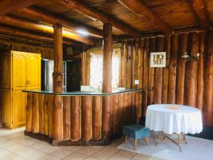 a room with wooden walls and a table in a room at Three Sons in Port Edward