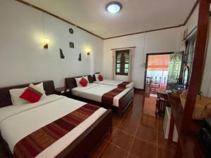 Postel nebo postele na pokoji v ubytování Vangsavath Hotel + 79 fotografií