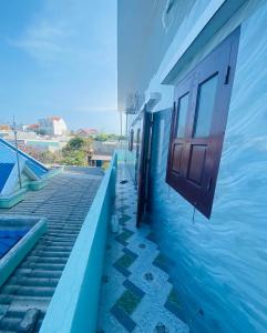 a building with an open door in the water at Xuan Huong Homestay in Cu Lao Thu
