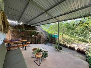 a patio with a table and potted plants at Mường sang farmstay in Mộc Châu