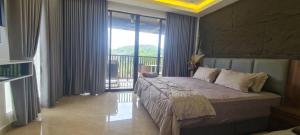 a bedroom with a large bed and a balcony at CBHResort Agrofarm in Kampong Benchah Tualang +32 photos