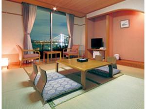 a living room with a coffee table and a couch at Kaikyo View SHIMONOSEKI - Vacation STAY 13686v in Shimonoseki