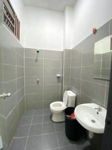 a bathroom with a toilet and a sink at HasYaa Homestay in Kampong Bukit Kuang +11 photos