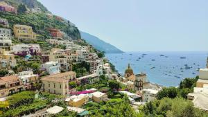 a view of a town on the side of a mountain at Manù Apartment in Vico Equense