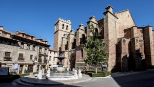 an old building with a fountain and a tower at Casa Rural Ríos in Mora de Rubielos