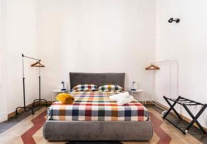 a bedroom with a large bed with two tables at Binario 8 Catania Stazione Centrale in Catania