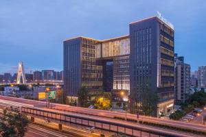 a city with two tall buildings and a highway at Skytel Hotel Chengdu-City Center in Chengdu