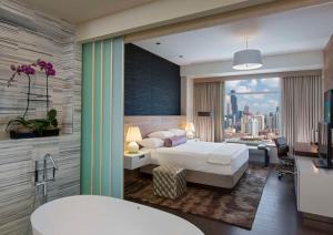 a bedroom with a bed and a view of a city at Hyatt Regency McCormick Place Chicago in Chicago +122 photos