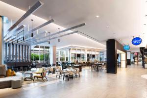 a restaurant with tables and chairs in a building at Hyatt Regency McCormick Place Chicago in Chicago