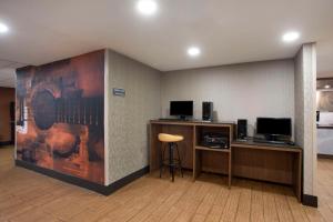 a room with a desk with a computer and a chair at Comfort Inn & Suites Nashville Downtown - Stadium in Nashville