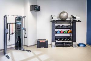 a room with a gym with a treadmill at Hilton Richardson Dallas, TX in Richardson