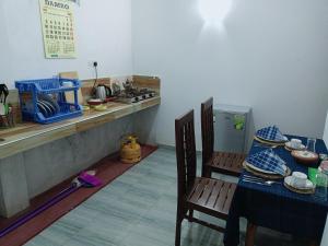 a kitchen with a table and chairs and a counter at Sunrise Relax Inn in Beruwala
